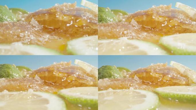 相机在斜坡上平移，上面撒满了蜂蜜和绿色柠檬片。超级宏观幻灯片。