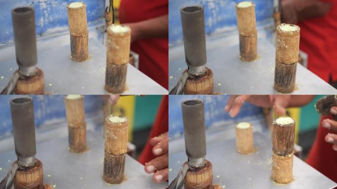 制作传统印尼小吃摊的过程，kue putu bambu。用米粉制成，用竹模制成。烹饪的哨声和香兰香气