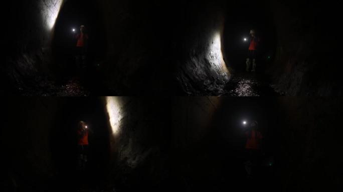 带手电筒的女挖掘机探索隧道
