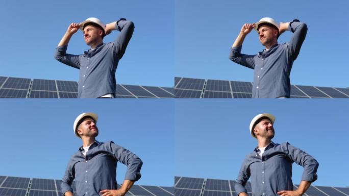 太阳能发电厂。站在太阳能电池板附近的人。可再生能源