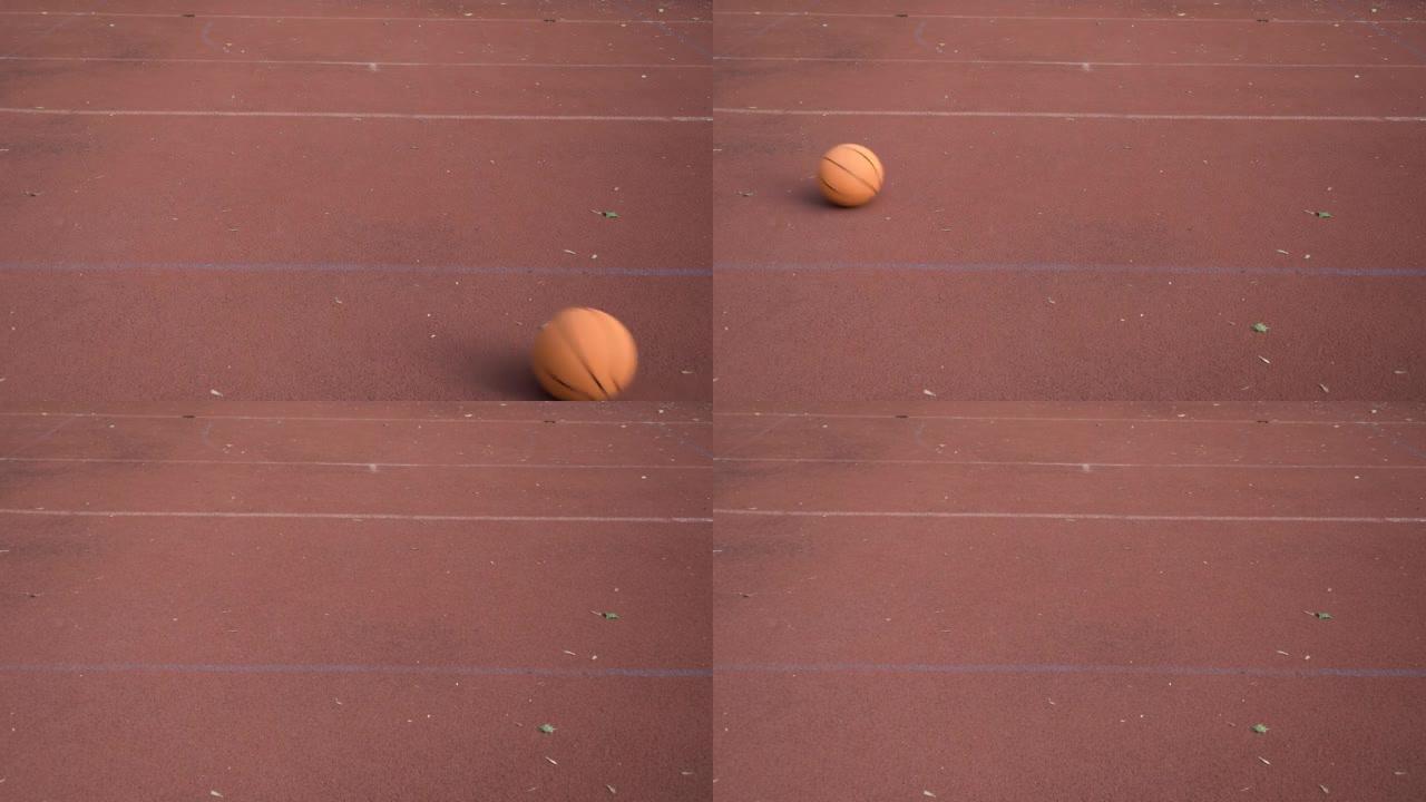 Basketball ball rolls through outdoor red street c
