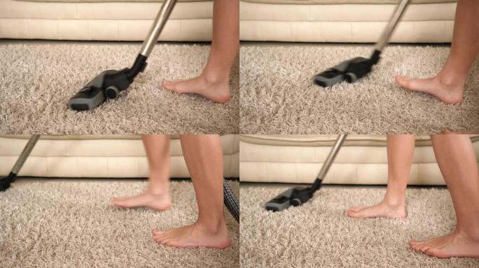 赤脚少女在家用吸尘器清洁房间地毯