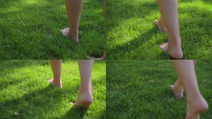 公园里，女性赤裸着双腿，沿着绿油油的草坪漫步。享受自然、生活、自由的理念。健康的生活方式。光脚和草地