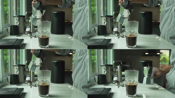 男人使用意大利比亚莱蒂经典的莫卡咖啡壶浇注概念，咖啡机配有设备工具冲泡台。4k视频