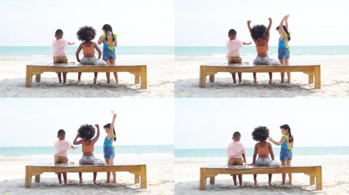 4k一群多元化的孩子暑假在海滩上一起玩。
