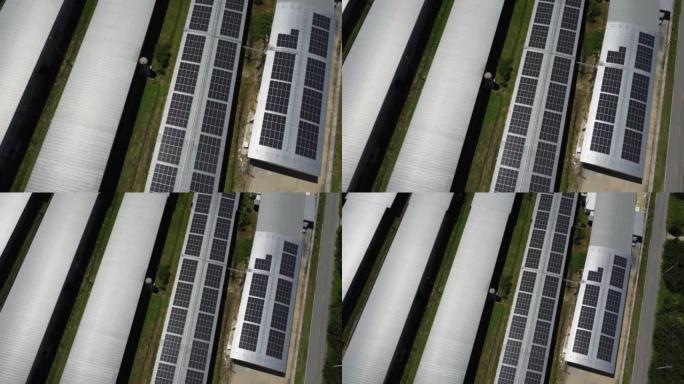 安装在大型工业建筑或仓库屋顶上的太阳能电池板的鸟瞰图。带工厂的太阳能发电站的俯视图。可持续能源概念。