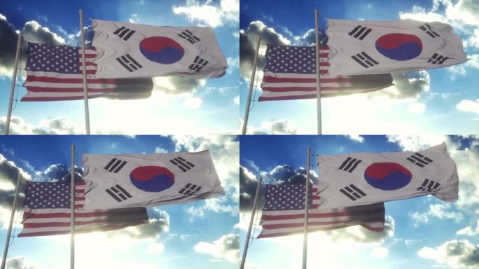旗杆上挂着韩国和美国的国旗。韩国和美国在风中挥舞着国旗。韩美外交概念
