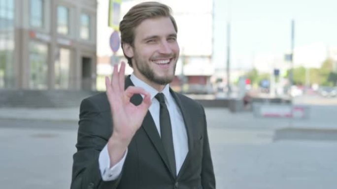 Businessman showing Ok Sign with Finger Outdoor