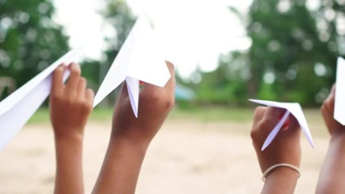 女孩玩由纸制成的有趣的飞机，创意，天然材料制成的玩具