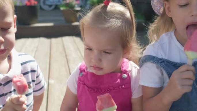 Three cute little Children enjoys delicious ice cr