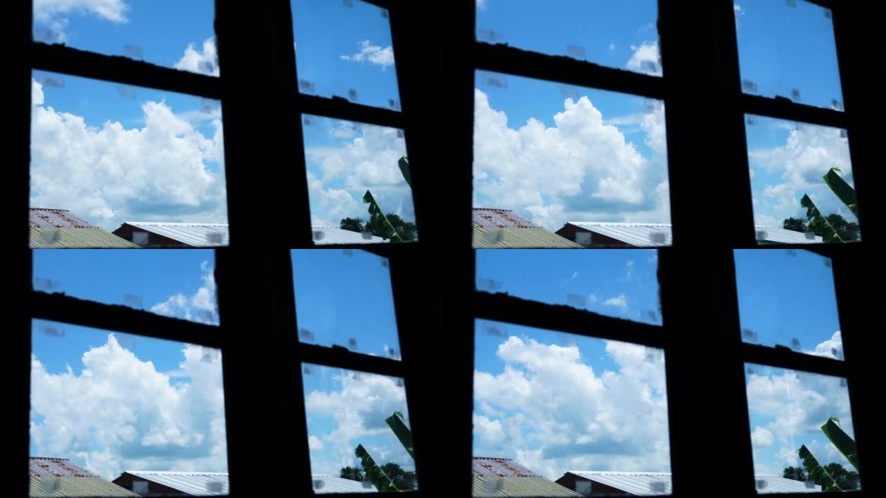 多云的云很快经过。有人从窗户里面看。监狱和没有自由的感觉。剪影。