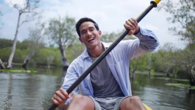 亚洲男子暑假在红树林皮划艇的4k肖像。