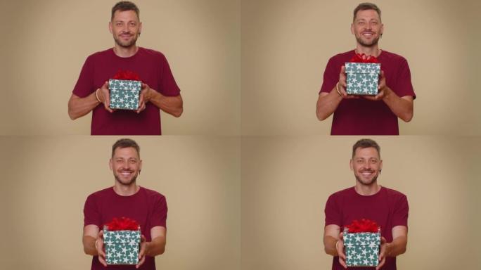 Handsome man presenting birthday gift box, offer w