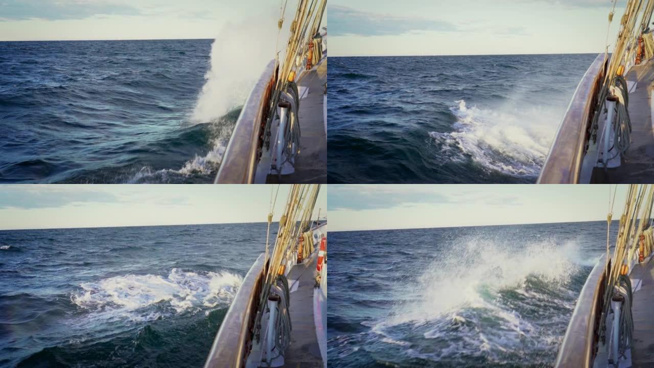 海上帆船。从船头的游艇甲板上看，特写。绿色海洋和波浪的侧视图。大浪的波罗的海。慢动作