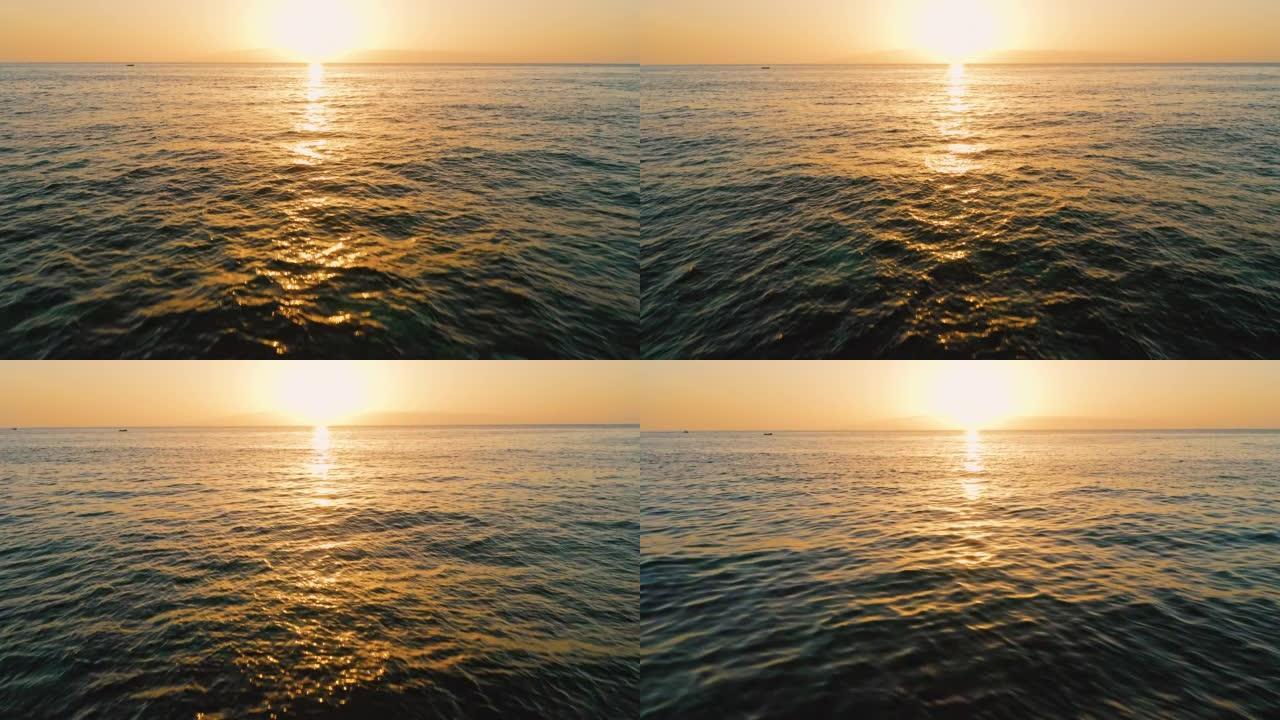 海上美丽的日落。金色清澈海洋咸水表面的太阳路径。晚上的风景。波浪起泡。天堂梦幻岛。无人机飞往太阳。