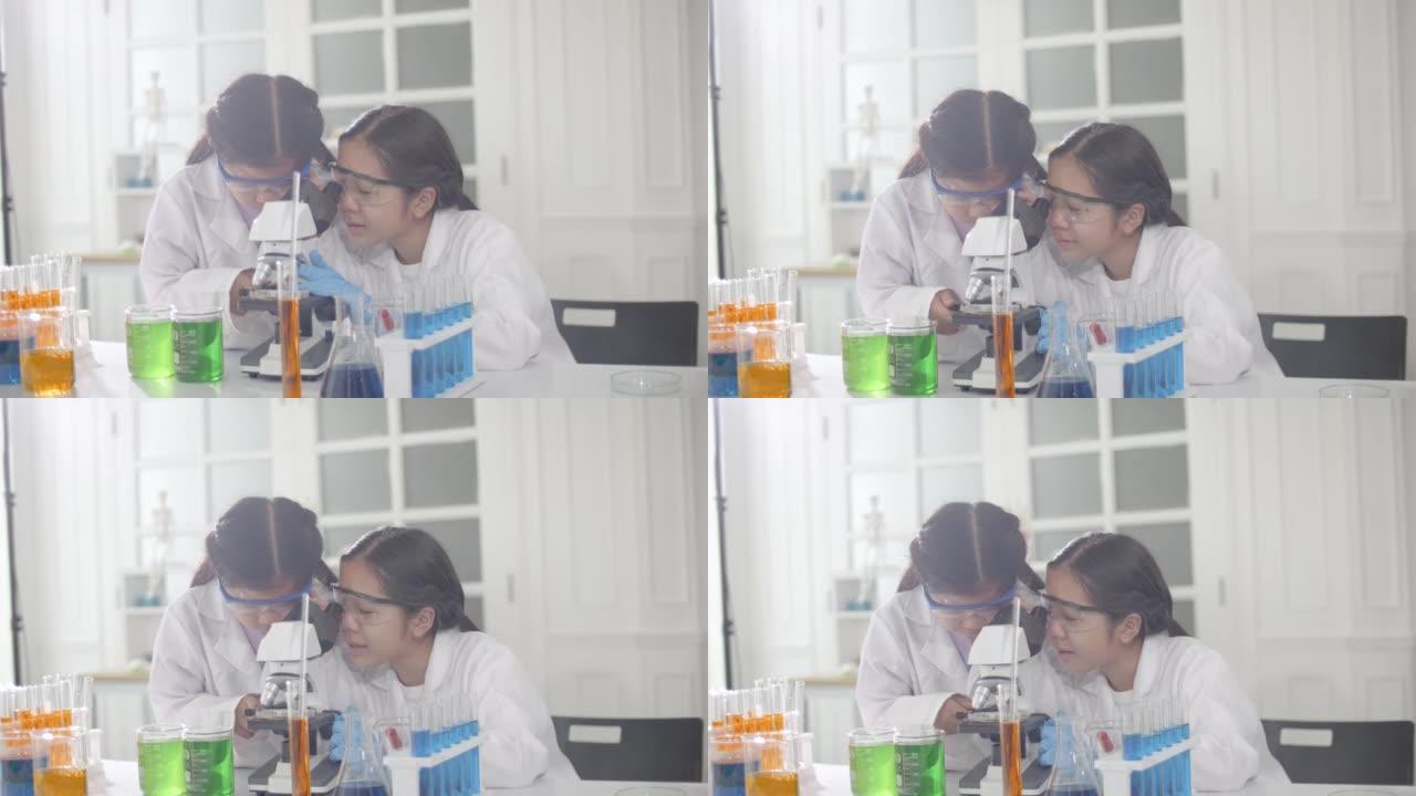 在教室实验室中使用显微镜进行科学实验的女学生