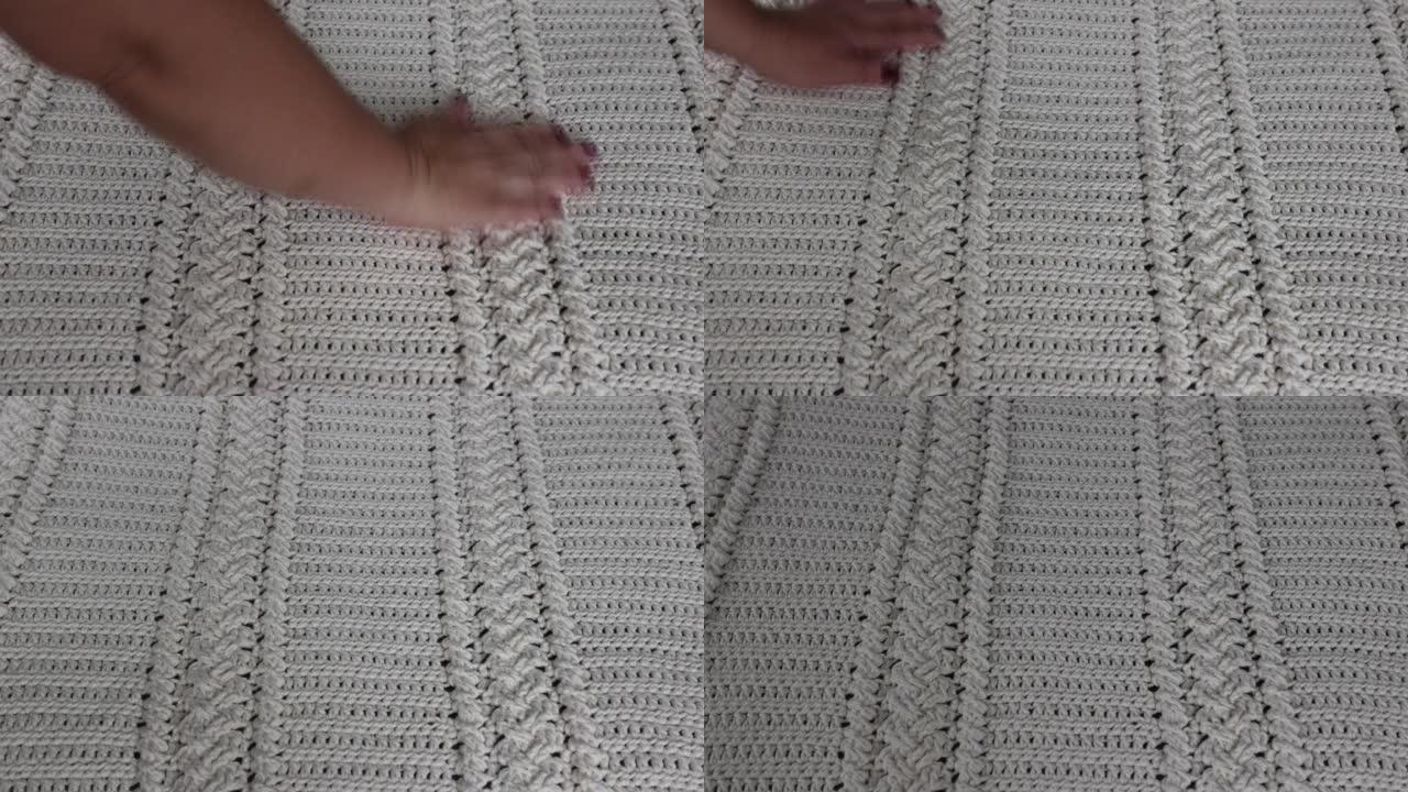 钩针编织毛毯的表面，编织成米色棉纱