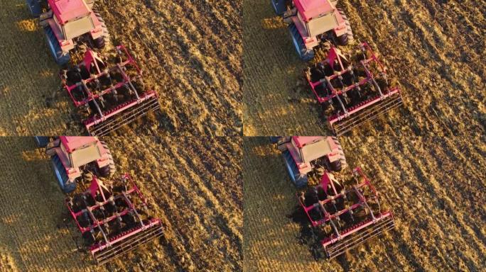 收割小麦收割后大型农业农场用旋耕犁拖拉机耕田的鸟瞰图