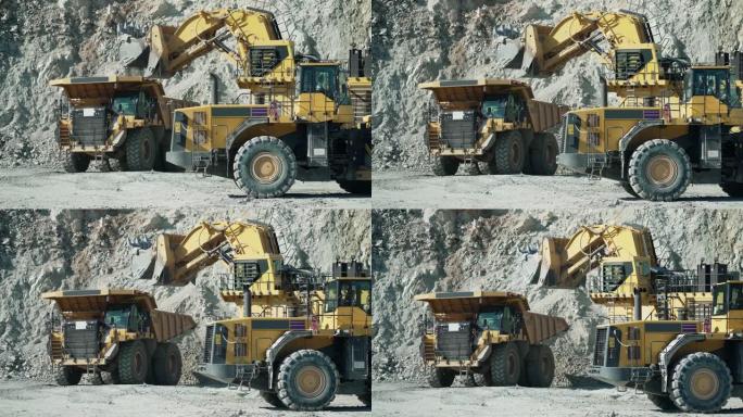 工业自卸车卡车和轮式装载机推土机在露天矿坑上工作，慢动作