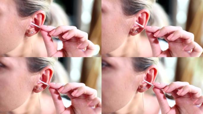 女人用棉签清洁耳朵特写4k电影慢动作