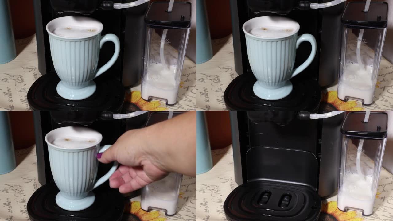 女性手的特写镜头拿着杯子，杯子里有美味的拿铁玛奇朵，放在电动咖啡机里