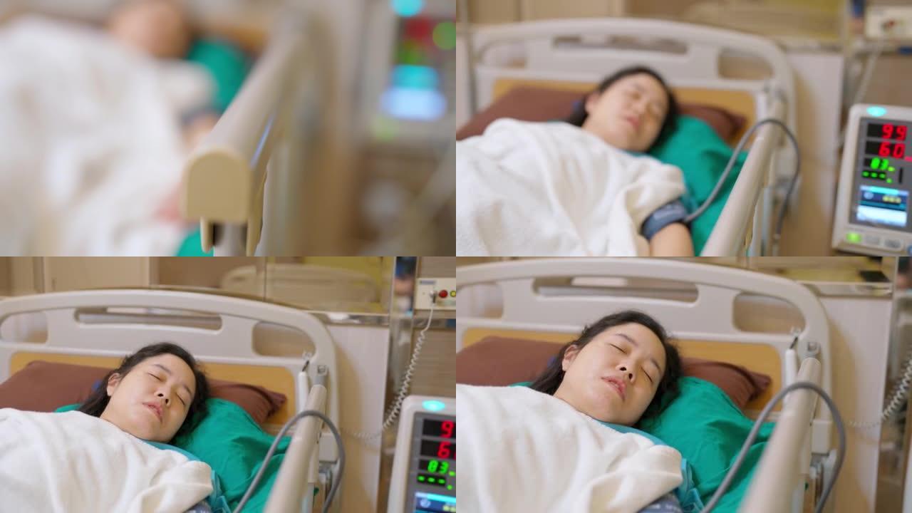 病人亚洲妇女在床上用盐溶液和监测血压在医院病房。治疗术后紧急恢复。高血压和低血压。医疗保健和医疗