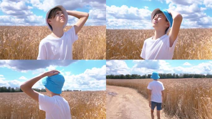 一个十几岁的男孩在麦田里看着天空的肖像，夏天阳光明媚的天气，移动的相机