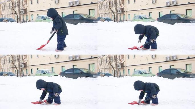 一个穿着冬装的小男孩挖雪