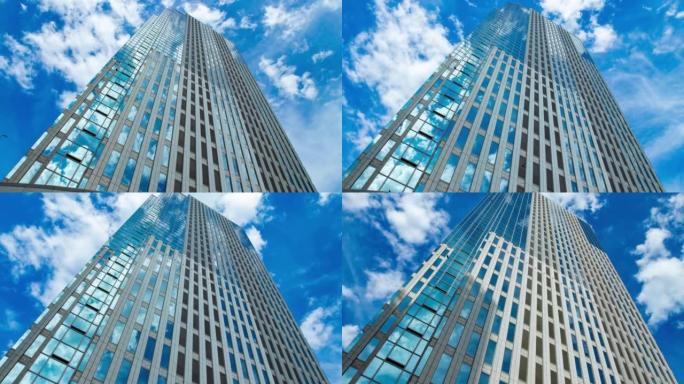 A timelapse of cloud reflecting the building in th