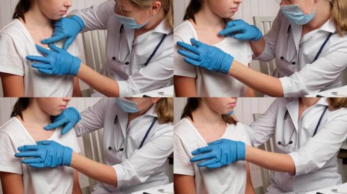 医生检查生病女孩的皮肤。红色皮疹的孩子正在医生那里检查。过敏性皮疹，水痘，猴痘症状对儿童的身体。健康