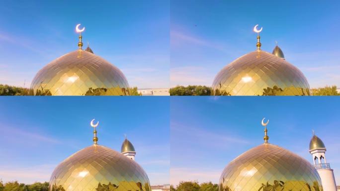 清真寺上有新月形月亮的穆斯林金色圆顶。尖塔映衬着天空。阿拉伯的一天。伊斯兰教的宗教符号。相信真主。清