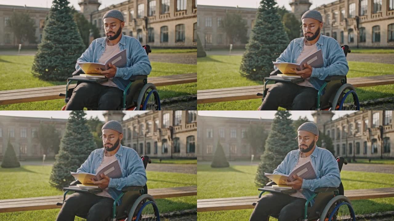 大胡子的黑人坐在轮椅上检查练习册
