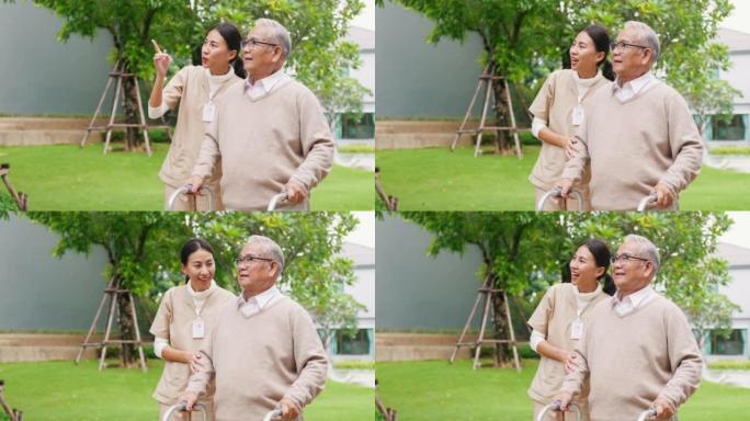 年轻的亚洲女性护理人员教老年男性走路使用助行器在公园户外牵着老年患者。