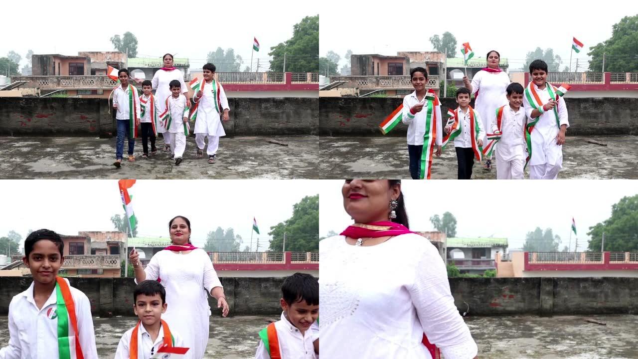 学生和老师举着印度国旗走在一起