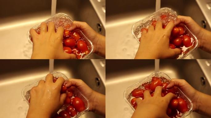 孩子在厨房水槽里洗樱桃番茄