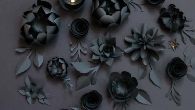 黑色背景上的黑色纸花。从纸上剪下。壁纸模板
