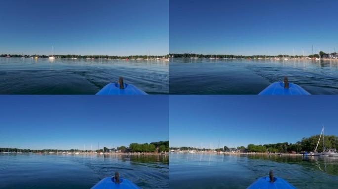 在皮划艇上滑过原始的蓝色湖水