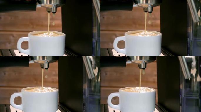 最后一滴浓缩咖啡从咖啡机掉进白色杯子里