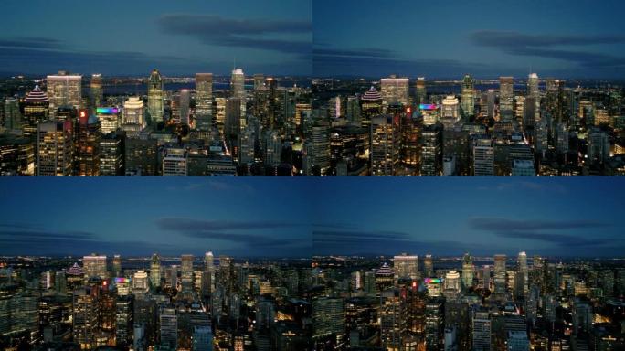 4k电影般的城市无人机镜头，拍摄了晚上在魁北克省蒙特利尔市中心的建筑物和摩天大楼的鸟瞰图。