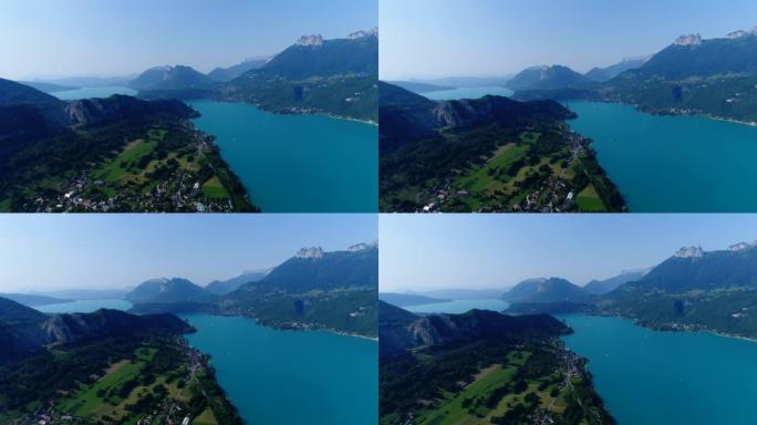 空中拍摄山湖，周围有田野和村庄