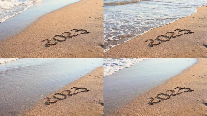 铭文2023在沙滩和海浪上。海边的日落。