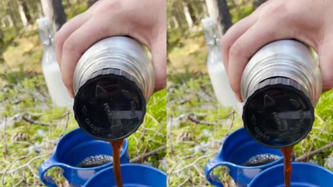 在森林的户外将咖啡倒入杯子的垂直镜头