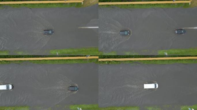 大雨过后，汽车在洪水泛滥的街道上行驶的城市交通鸟瞰图。道路排水系统存在的问题