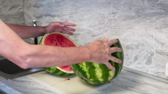 一个人用刀切了一个大西瓜。高级男子切红西瓜