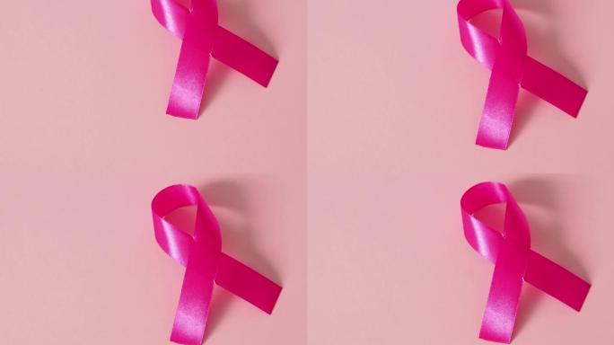 粉红丝带形状粉红纸背景为乳腺癌意识标志，促进10月月活动。俯视图背景