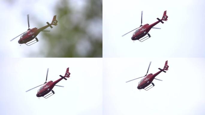 红色救援直升机飞越树木