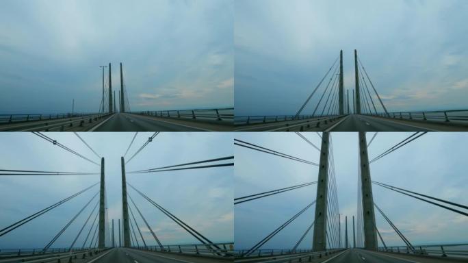 在横跨丹麦和瑞典的厄勒海峡大桥上行驶。大型悬索桥。