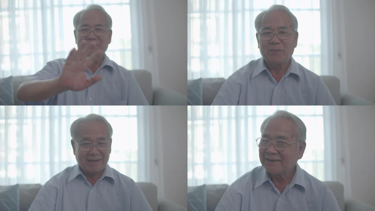 亚洲华裔老人视频打电话给家人，看着相机说话