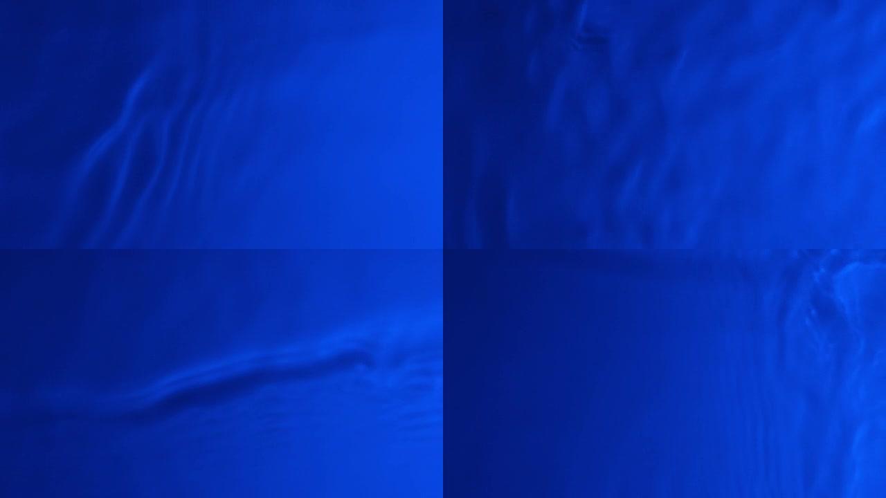 霓虹蓝水渐变纹理，带有水滴、飞溅和波浪。有机水调在海军蓝渐变中，折射光慢动作视频横幅。