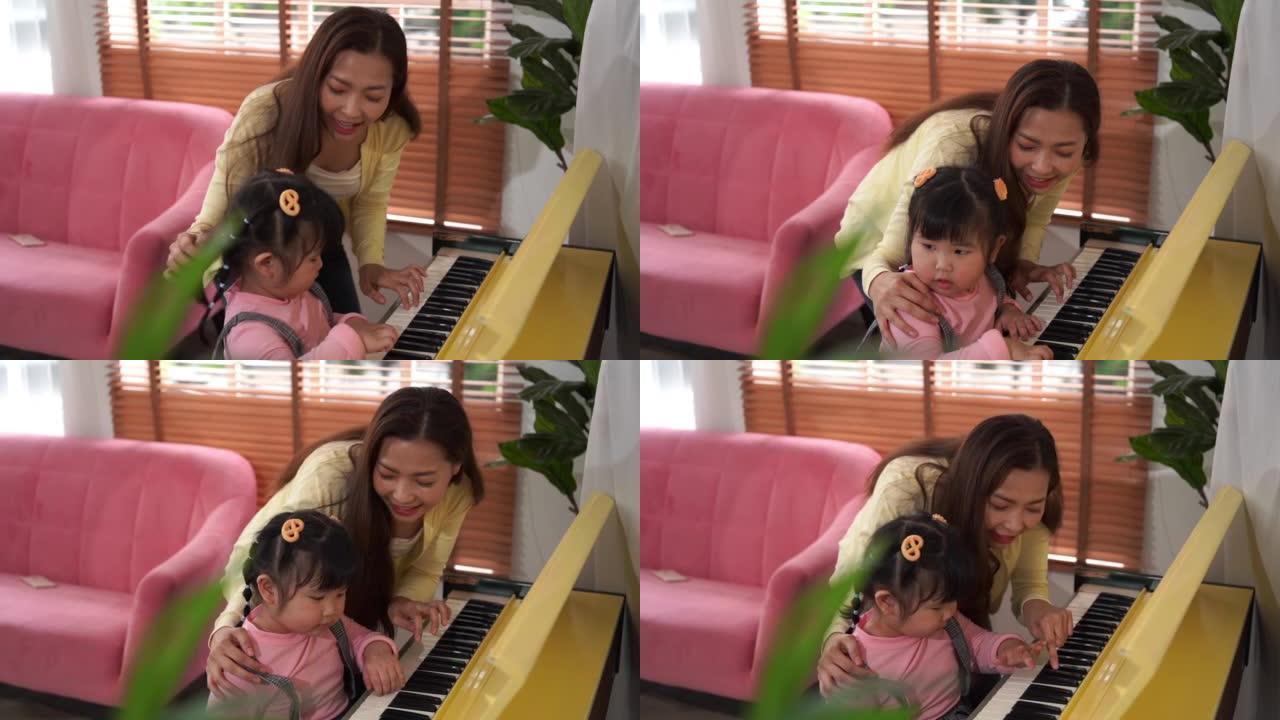 周活动，亚洲家庭，唱歌，母亲为女儿教钢琴，在家娱乐